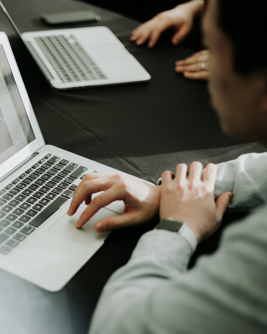 Person typing on a laptop while chatting with an AI assistant