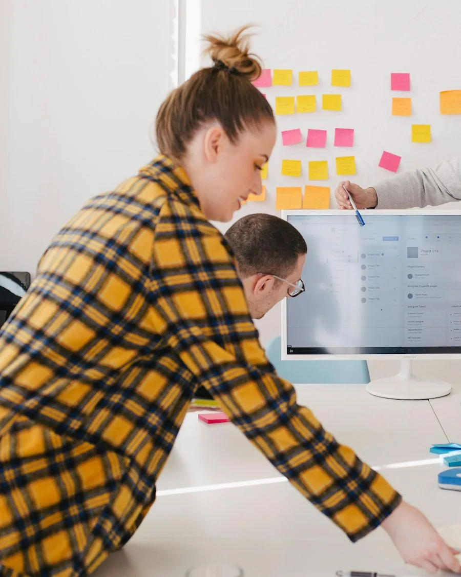 Business analyst planning activities on a wall of sticky notes